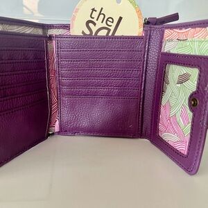 New The Sak plum leather trifold wallet with gold-copper hardware & stitching.